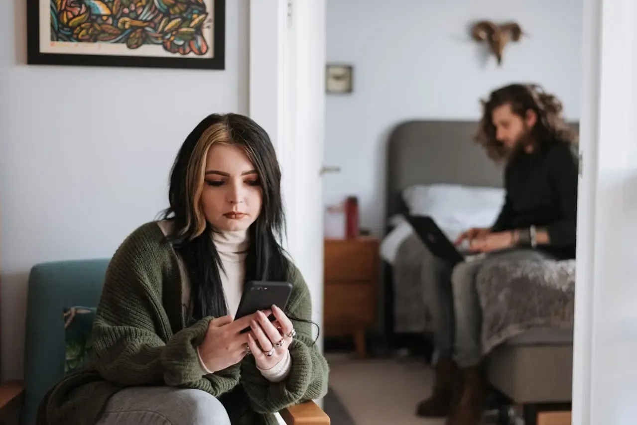 a woman checking her boyfriend's phone